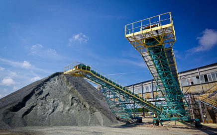 Pile of brown coal and loading equipment at the storage