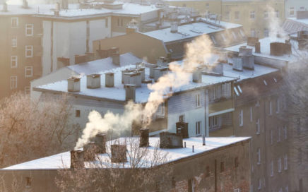 Smoking chimneys in Szczecin city at sunrise indicate burning of wood and coal in old home heating systems. Residents in many Polish cities complain of increasing health problems due to air pollution.